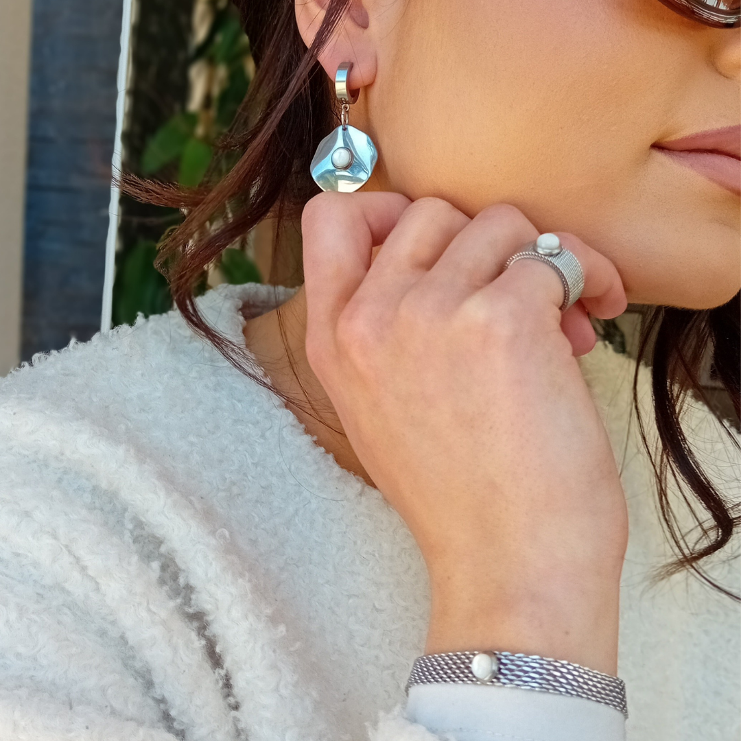 LUNË bracelet styled on wrist with natural light, combining structured steel with soft mother of pearl for a modern, minimalist look.