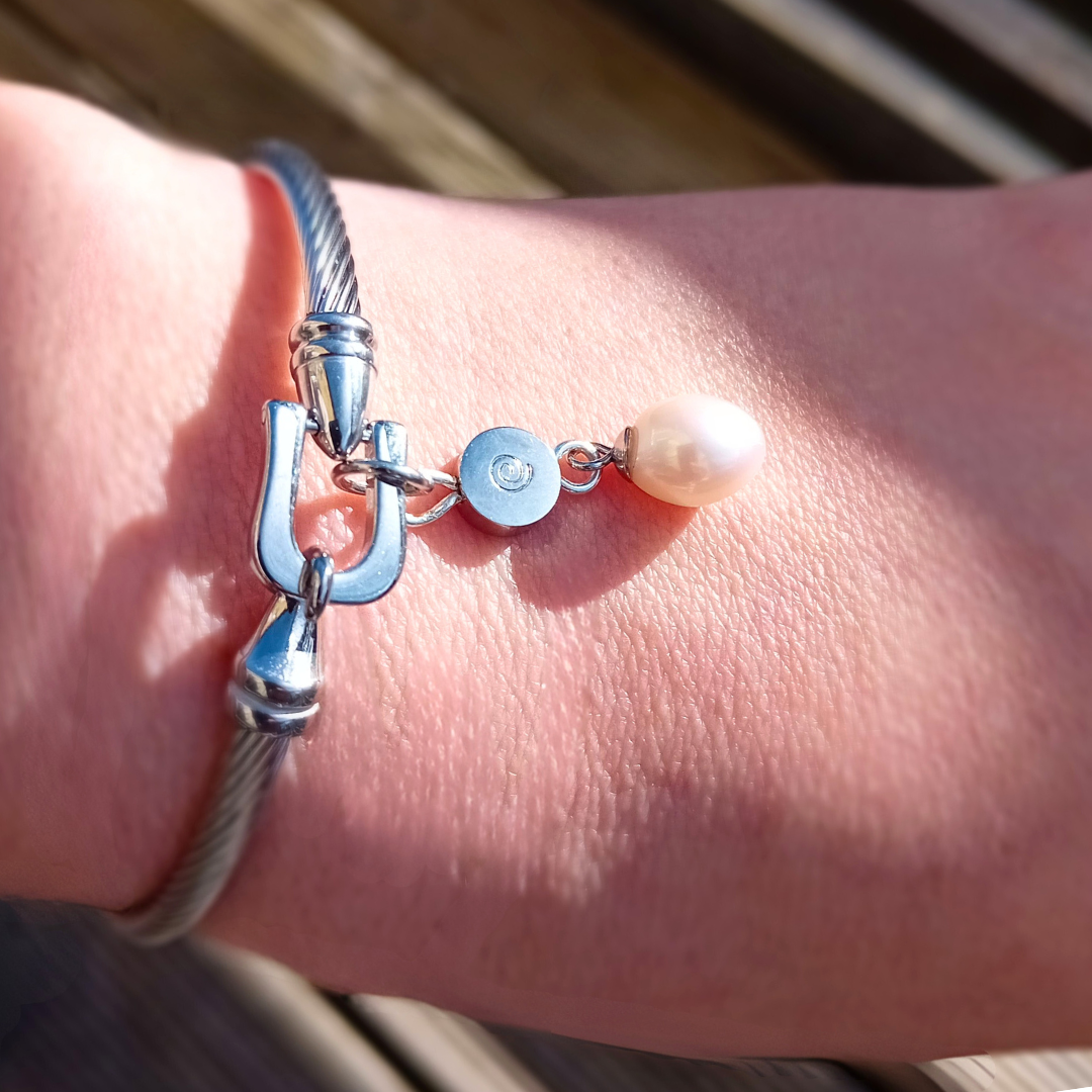 stainless steel bracelet with freshwater pearl worn on hand