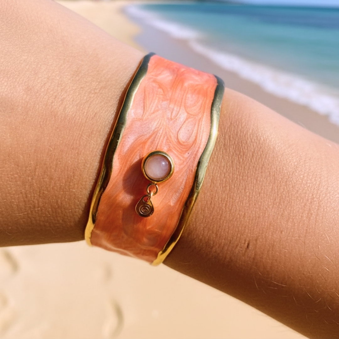 SUNKISSED armband buret på handled – bred korallrosa emaljmanschett med 18k guldpläterade kanter och solsten med spiralcharm
